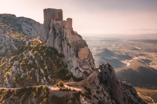 a castle on top of a mountain at CROUXETO Chambres d'hôte in Duilhac