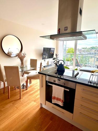 a kitchen with a sink and a stove top oven at Flat in Arsenal Islington Central London in London