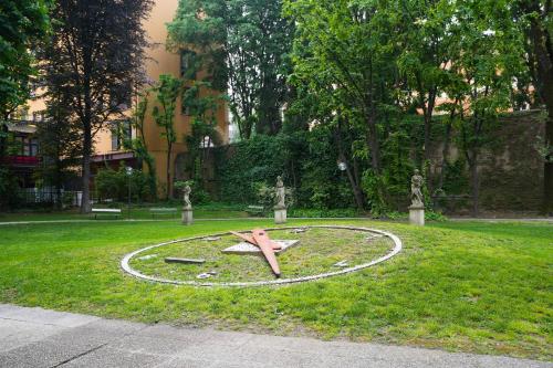 a clock in the grass in a park at Mercure Bologna Centro in Bologna
