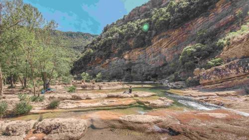 a river in the middle of a canyon at CROUXETO Chambres d'hôte in Duilhac