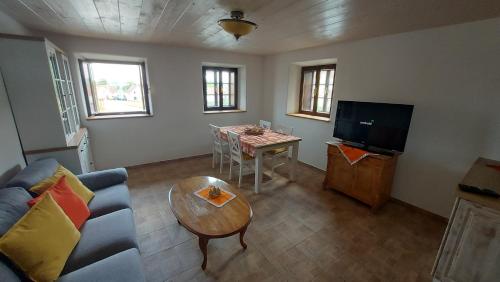 a living room with a couch and a table at Prázdninový dům in Habří