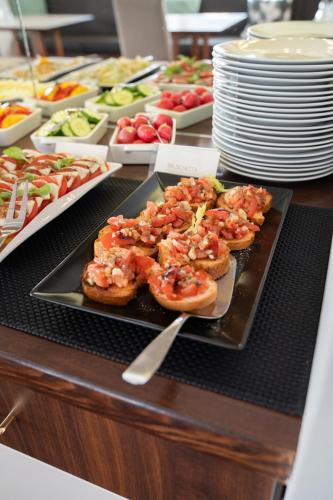 a buffet with shrimp appetizers on a plate on a table at ChiemseeStern Vacation & Recreation "Adults Only" in Gstadt am Chiemsee