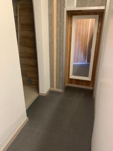 a hallway with a door and a window at Appartment Emosson 2 in Finhaut