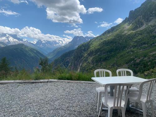 a table and chairs sitting on top of a mountain at Appartment Emosson 2 in Finhaut