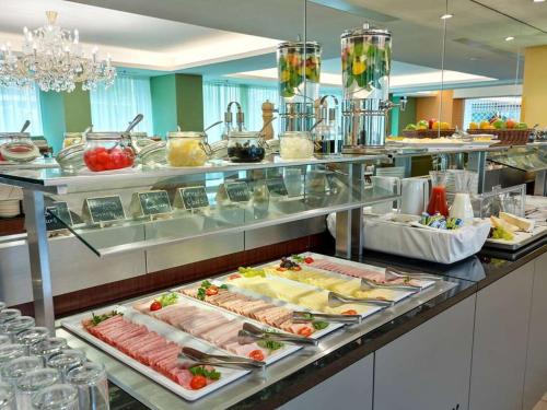a buffet line with meats and cheese and other foods at Ibercity Wien Schönbrunn in Vienna