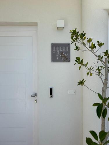 a clock on a wall next to a door at Le Dimore di Fefè in Alberobello