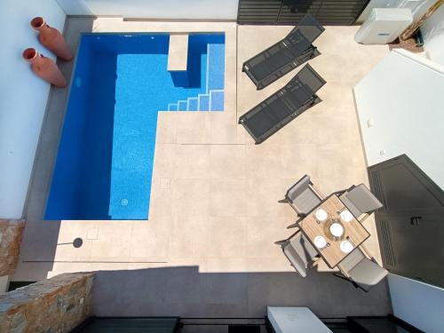 an overhead view of a swimming pool with lounge chairs and a swimming pool at Villa Verano San Javier - 6610 in San Javier