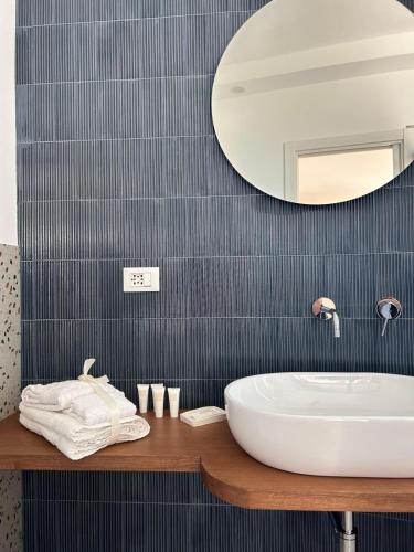 a bathroom with a white sink and a mirror at Le Dimore di Fefè in Alberobello