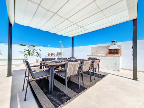 an open kitchen and dining room with a table and chairs at Villa Verano San Javier - 6610 in San Javier