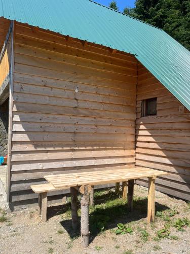 a wooden building with a bench in front of it at Komovi-Apartment in Kolašin