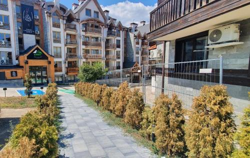 a row of trees in front of a building at Penthouse Harriet Bansko in Bansko
