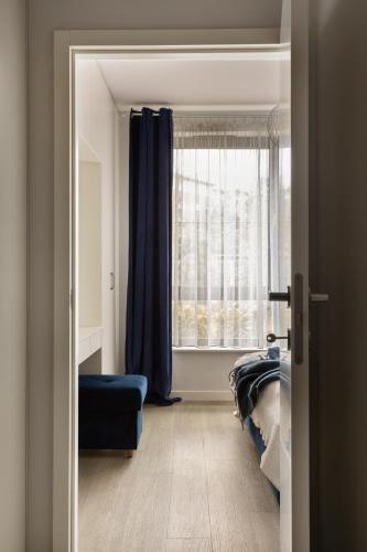 Ένα ή περισσότερα κρεβάτια σε δωμάτιο στο Scala Apartamenty by Moderna Profit- Łąkowa 60E z parkingiem