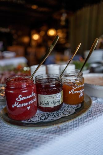 two jars of jam sitting on a table at Berghotel Blaickner's Sonnalm in Zell am See