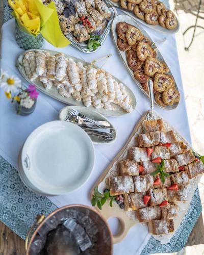 a table topped with different types of food on plates at Berghotel Blaickner's Sonnalm in Zell am See