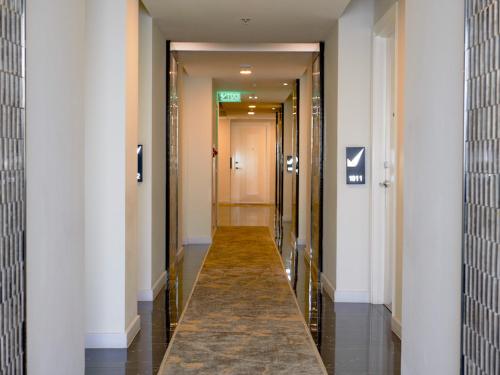 a hallway of a building with columns and a long corridor at Verse Luxe Hotel Wahid Hasyim in Jakarta