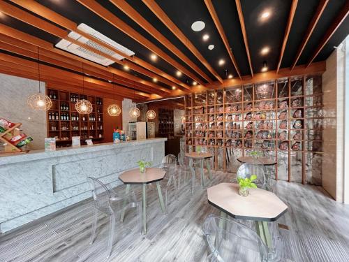 a restaurant with chairs and a bar with wine racks at Verse Luxe Hotel Wahid Hasyim in Jakarta