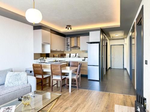 a living room and kitchen with a couch and a table at Adriatic Masterpiece Residence in Sveti Stefan