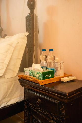 a table with two bottles of water on top of a bed at Jaisalmer Elite Castle in Jaisalmer
