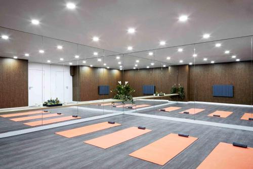 a large room with orange yoga mats on the floor at Virexxa Bedford Centre - Alpha Suite - 2Bed Flat with Free Parking & Gym in Bedford