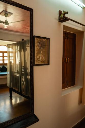 a mirror on a wall with a picture on it at Jaisalmer Elite Castle in Jaisalmer