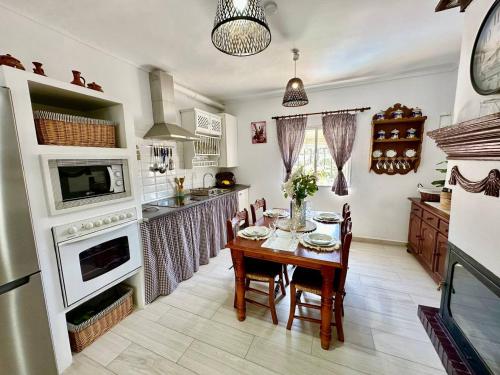 a kitchen with a table and a dining room at La casa de mis padres in Júzcar
