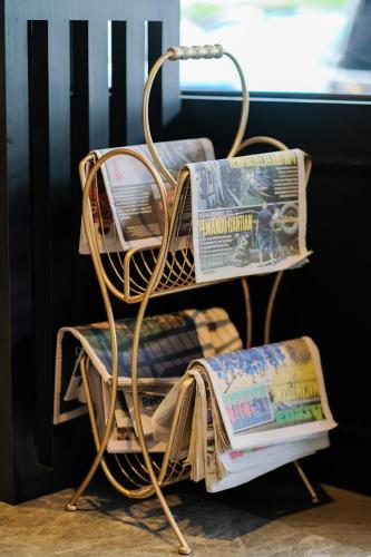 a newspaper rack with newspapers and magazines on it at NB HOTEL in Johor Bahru