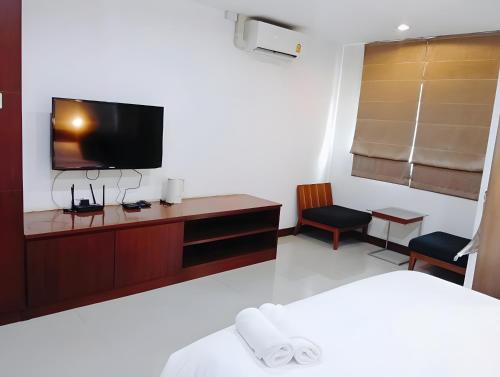 バンコクにあるYon INN Sukhumvit Soi 4 - BTS Nanaのテレビ、ベッドが備わるホテルルームです。