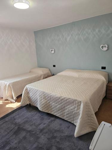a bedroom with two beds in a room at Regina Margherita affittacamere in Aulla