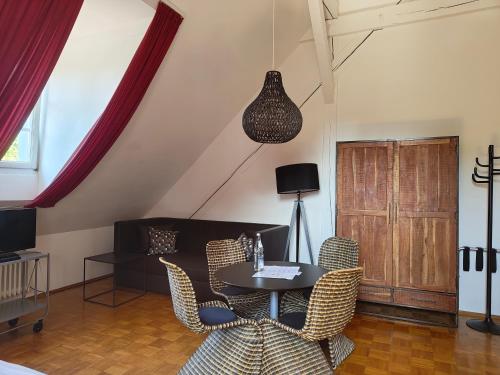 a living room with a table and chairs at WHLIVING - Apartments & Studios in Konstanz in Konstanz