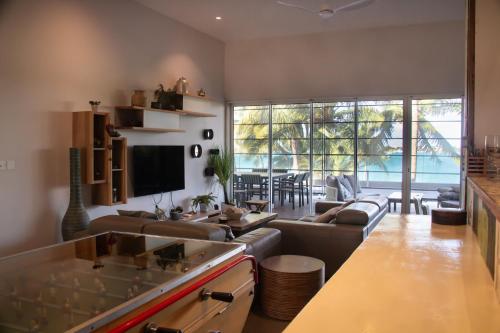 a living room with a couch and a table at Beachfront Penthouse 3 bedrooms - Grand Baie Mauritius in Grand Baie