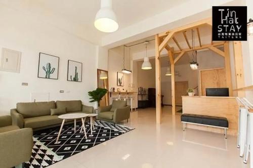 a living room with a couch and a table at 廷海特潮流民宿 漢中館 民宿編號1746 寵物友善陽台房 近微光集與鐵道藝術村 in Taitung City