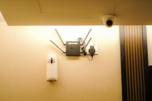 a wall with a clock and a speaker on a wall at NB HOTEL in Johor Bahru