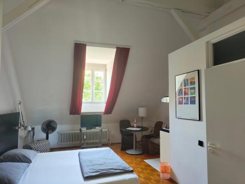 a bedroom with a bed and a window and a table at WHLIVING - Apartments & Studios in Konstanz in Konstanz