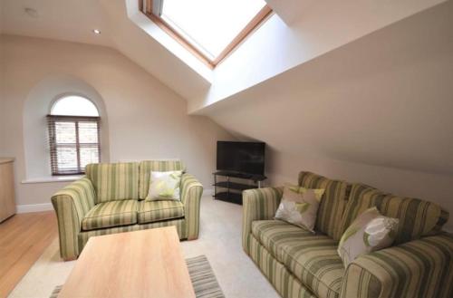 a living room with two couches and a tv at Cosy 2 Bedroom Apartment With Free Parking in Sheffield