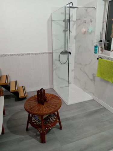 a bathroom with a shower with a wooden table and a stool at Christian in Cruce de Arinaga