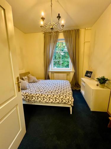 a bedroom with a bed and a window at Manto Apartment in Klaipėda