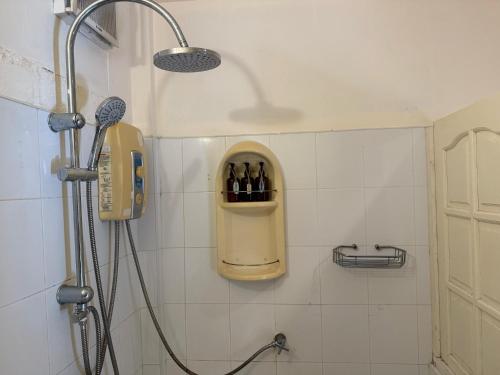 ein Bad mit einer Dusche und Weinflaschen in der Unterkunft Natural Wing Health Spa and Resort in Ban Bang Po