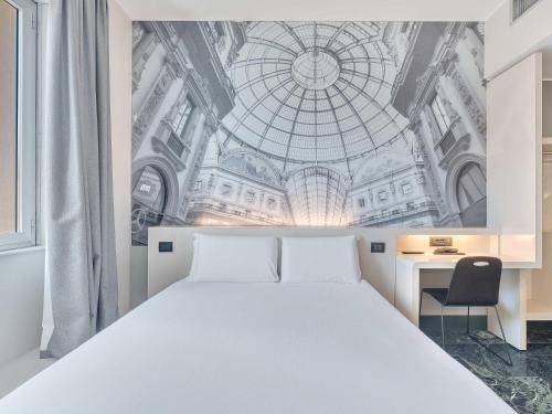 a bedroom with a large bed with a ceiling at B&B Hotel Milano Sant'Ambrogio in Milan
