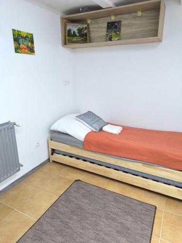 a bed in a room with avertisementatronatronstrationstrationstrationstration at E-Tekergők Háza in Bükkzsérc
