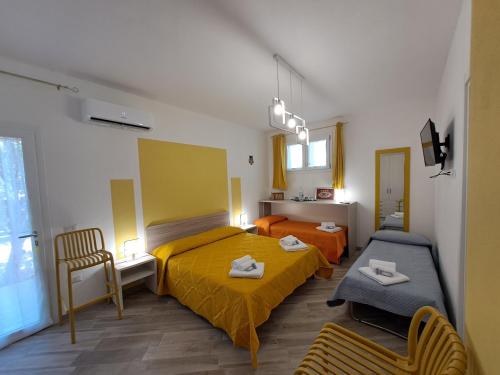 a small bedroom with a bed and a couch at I Sette Ulivi Bed and Breakfast in Tergu
