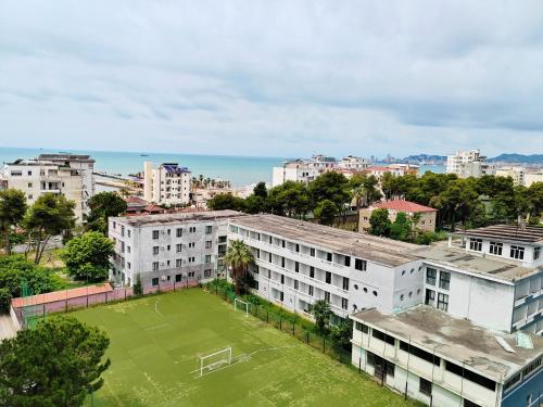 an apartment building with a soccer field in a city at MiKi Apartmán Durrës in Durrës