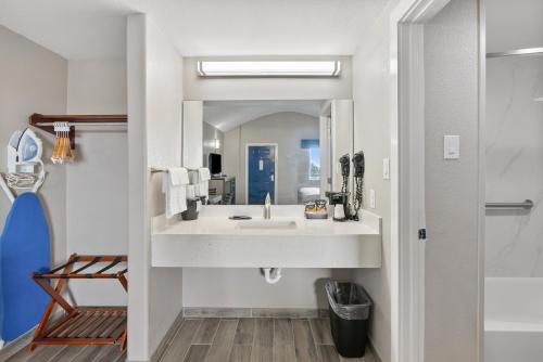 a bathroom with a sink and a mirror at Blue Wave Inn in Rockport