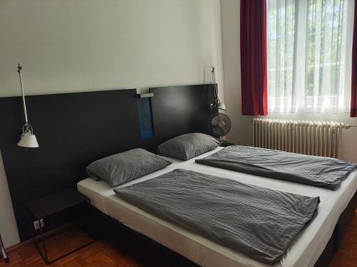 a bed with two pillows on it in a bedroom at WHLIVING - Apartments & Studios in Konstanz in Konstanz