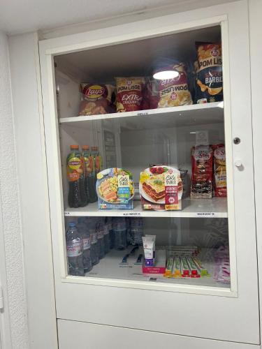 a refrigerator filled with lots of food and drinks at Premiere Classe Arras - Tilloy Les Mofflaine in Tilloy-lès-Mofflaines