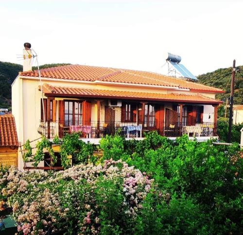 a house with a woman standing on top of it at Andromahi Studios in Lefokastro