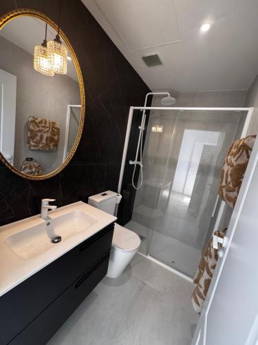 a bathroom with a shower and a sink and a mirror at Apartamento Casa la Rubia Jaca in Jaca