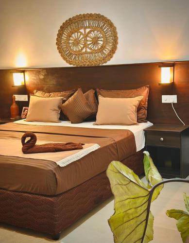 a bedroom with two beds with a headboard at Bananas Palm Villa in Mirissa