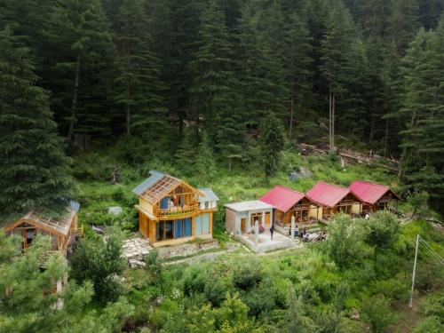 an aerial view of a house in the woods at Glass House by Himalayan Cedar Nest in Sainj