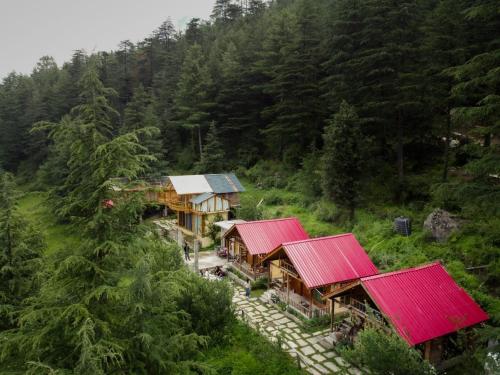 an aerial view of a house with red roofs at Glass House by Himalayan Cedar Nest in Sainj