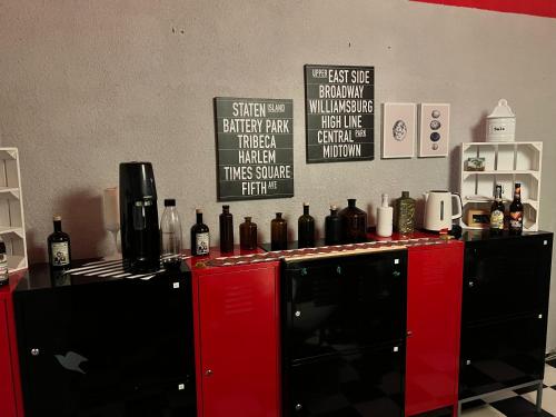 a kitchen with a counter with bottles on it at Pension Frosch Hostel in Berlin